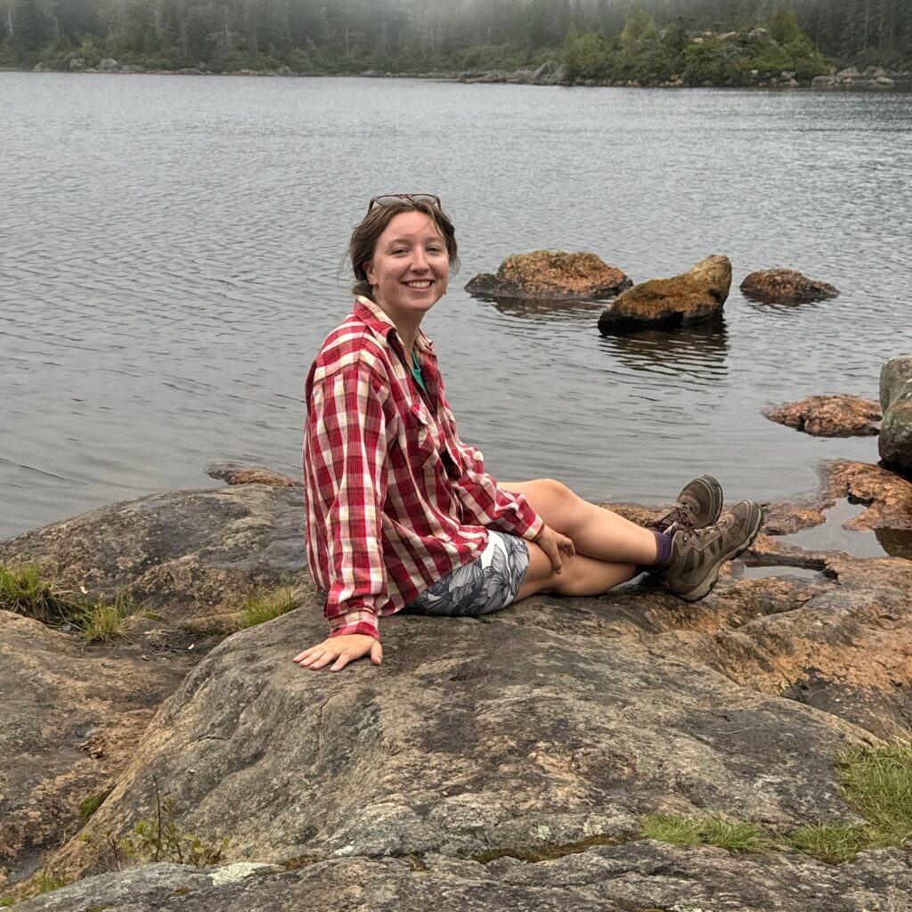 Megan Forbes sitting on a rock