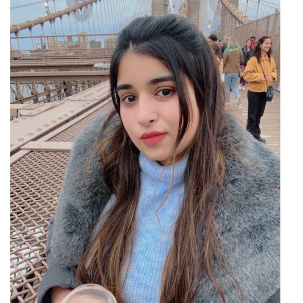 Riya Rajdev drinkng coffee on the bridge