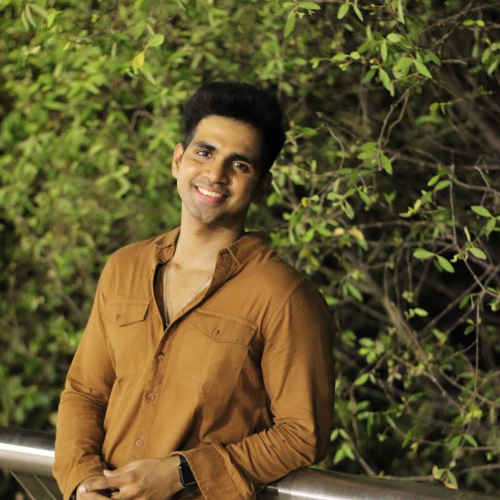 SHASHANK MISHRA posing by a tree