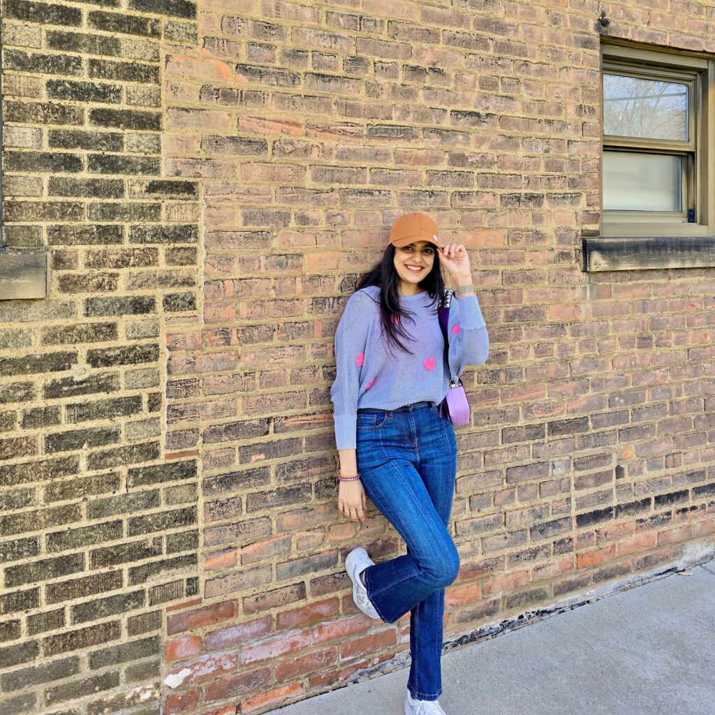 hiral patel posing against a brick wall